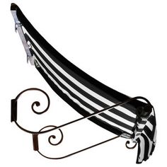 a black and white striped hammock hanging from a wrought iron stand with an umbrella attached to it