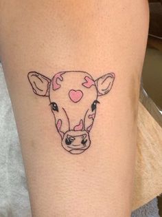 a small tattoo of a cow's head with hearts on its forehead and nose