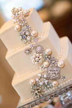 a wedding cake with pearls and jewels on it