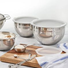 three stainless steel mixing bowls and two measuring spoons