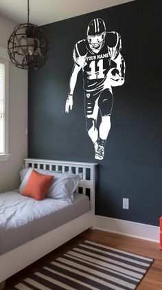 a bedroom with a football player decal on the wall