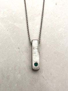 "Unique Silver Bar Textured Pendant Necklace For Men. Unique Emerald Silver Jewelry, Handmade by OmriGoren. This is a 925  sterling silver Necklace and a hand-made textured Silver Bar pendant. A beautiful piece of raw Emerald is held in a frame set as a centerpiece. This truly Unique Bar Necklace For Men is the perfect piece of jewelry for meaningful events Or everyday outfits, an art piece that cannot be ignored! My new unique men's jewelry collection combines metals and gemstones, creating a u Bar Necklace Men, Unique Mens Necklace, Man Bars, Raw Emerald, Anniversary Necklace, Silver Bar Necklace, Necklace Men, Silver Bar, Anniversary Gifts For Husband