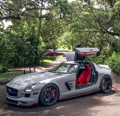 the mercedes sls amg is parked in front of some trees