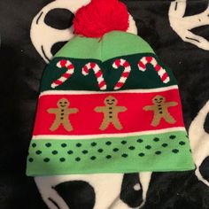 Light Up Beanie Hat With Candy Canes And Gingerbread Man Over It And Red Puffy Ball Red Holiday Hats For Winter, Casual Christmas Hat, One Size Fits Most, Casual Christmas Hat One Size Fits Most, Casual Christmas Hat, Casual Beanie Christmas Hats, Casual Christmas Beanie Hat, Christmas Tree Hat, Mens Ugly Christmas Sweater, Elf Christmas Tree