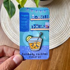 a person holding up a business card with an image of a drink