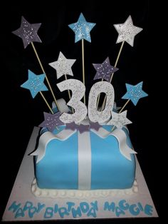 a blue and white birthday cake with stars on it's top that reads 30