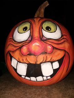 a pumpkin with an evil face painted on it