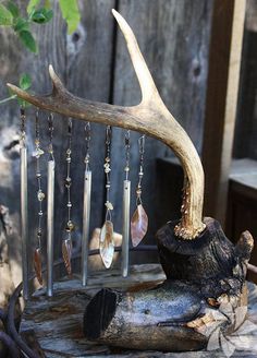 a piece of wood that has some kind of jewelry hanging from it's side