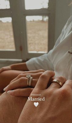 a man and woman holding hands in front of a window with the words married written on it