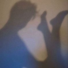 the shadow of a person holding a cell phone