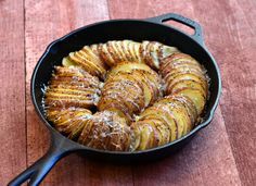 baked potatoes in a cast iron skillet ready to be cooked for dinner or dessert