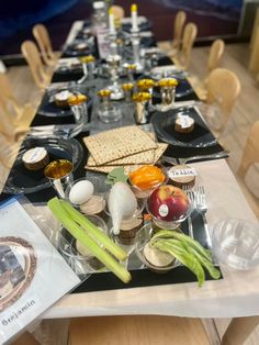 a long table is set up with plates and utensils for an appetizer