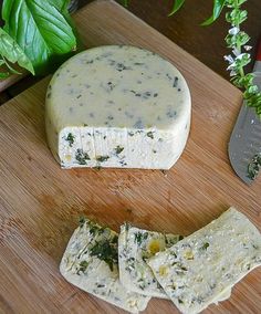 a piece of cheese sitting on top of a wooden cutting board next to a knife