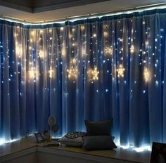 a window with blue curtains and lights on it