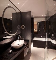 a large bathroom with two sinks and a bathtub in it's own area