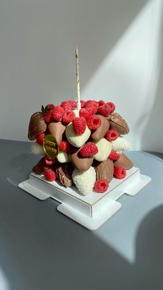 a birthday cake with chocolate and raspberries on it