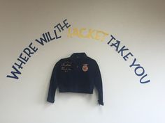 a blue jacket hanging on the wall with words written below it that read, where will the jacket take you?