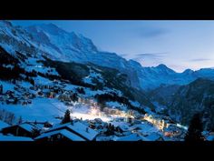 a snowy mountain town lit up at night