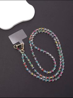 Multi Color Beaded Phone Lanyard Experience the captivating sparkle of our multi-color bead phone lanyard. This premium phone accessory features a brilliant array of colored glass beads, each one reflecting light in a delightful array of hues. Durable and stylish, this multi-color bead lanyard is the perfect combination of functionality and fashion.Material: Abs Color: Multi color with clear glass bead lanyard Gender: Unisex Type: Beaded phone lanyard Style: Trendy Width: 2.4 Length: 25.6 l Osun Lanyard Beads Design Ideas, Diy Beaded Lanyards, Beaded Lanyards Diy, Phone Lanyard Beads, Diy Lanyards, Beaded Phone Lanyard, Bead Lanyard, Diy Lanyard, Glasses Strap