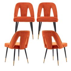 four orange velvet chairs with black legs and gold studding on the backrests