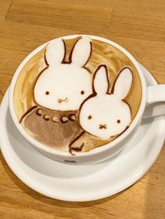 a cappuccino with two rabbits painted on it