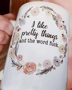 a woman holding a coffee mug with the words i like pretty things and the word fluck on it