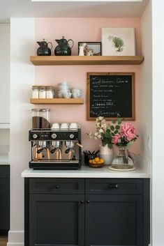 a coffee machine sitting on top of a counter next to a chalkboard with writing on it