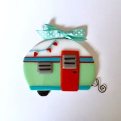 an ornament shaped like a camper with a bow