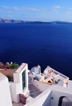 the stairs lead down to an ocean view from a house in oia, greece