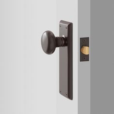 an open door with a black handle on the front and side of it, next to a white wall