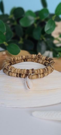 two wooden bracelets sitting on top of a surfboard