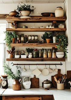 pots and pans on wooden shelves in a kitchen