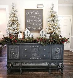 an old dresser is decorated with christmas trees and garlands for the holiday decorating