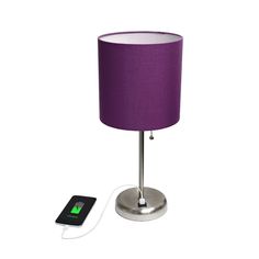 a lamp with a charger plugged in to it next to a purple lampshade