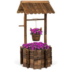 a wooden structure with flowers in it and a potted planter on the top