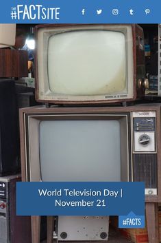 an old tv sitting on top of a wooden table next to other televisions and speakers