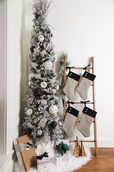 a christmas tree with stockings hanging from it