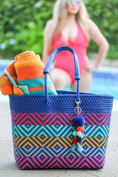 These premium tote bags have bright vibrant colors and are the perfect addition to your outfit. This bag features a double weaving technique requiring more material visible in the cross color detailed pattern. It also makes the bag extremely sturdy. The bag features inner lining, pockets, closure, vinyl handles, and a handcrafted pompom. Beach Satchel Bag With Detachable Handle, Rectangular Vacation Bag With Detachable Handle, Beach Tote Shoulder Bag With Detachable Handle, Beach Shoulder Tote Bag With Detachable Handle, Summer Tote Bag With Detachable Handle, Beach Bag With Detachable Double Handle, Beach Satchel With Detachable Handle, Beach Satchel With Detachable Shoulder Handle, Summer Bags With Removable Pouch