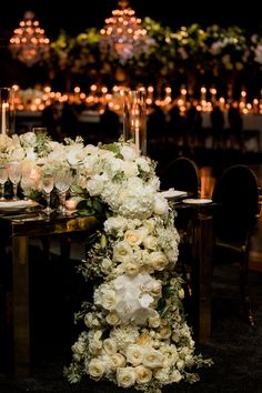 a table with flowers and candles on it