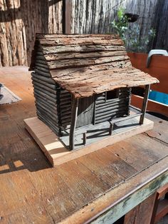 a small wooden house sitting on top of a table