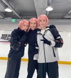 three young men standing next to each other in front of an ice rink with pink hair