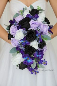 a bridal bouquet with purple and white flowers in the bride's hand,