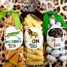 three bags filled with cookies and marshmallows on top of a leopard print table cloth