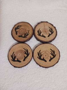 four pieces of wood that have been carved into the shape of deer's antlers