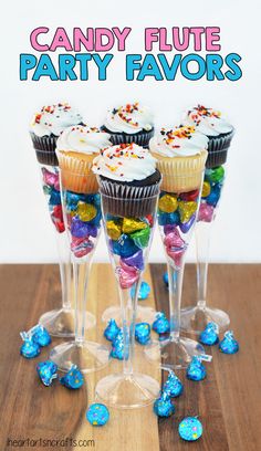 cupcakes and candy in wine glasses on a table with the words candy flute party favors