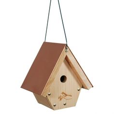 a wooden birdhouse hanging from a string