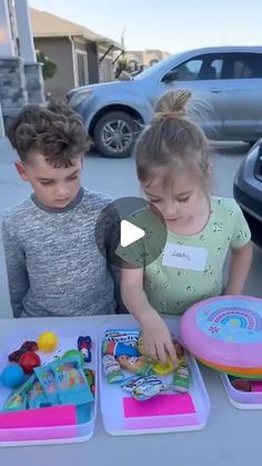 two children are playing with toys at a table