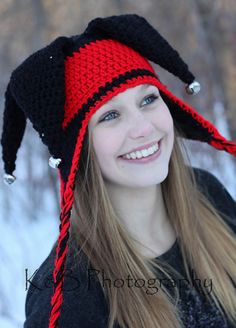 a woman wearing a red and black crocheted hat