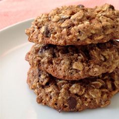 three oatmeal cookies stacked on top of each other in a white plate