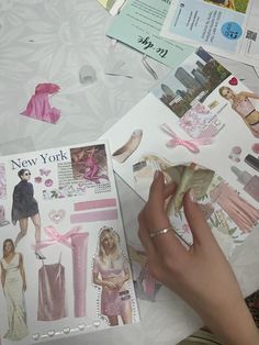 a person is making new york fashions with paper and other things on the table